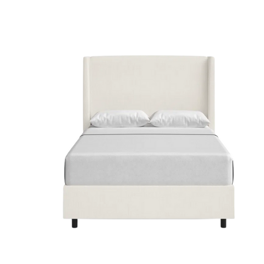 White linen upholstered king size bed with foam-padded wingback headboard, black low-profile metal legs, and sturdy wood frame.

