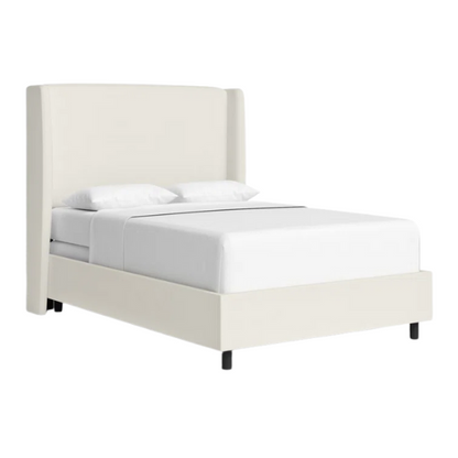 White linen upholstered king size bed with foam-padded wingback headboard, black low-profile metal legs, and sturdy wood frame.

