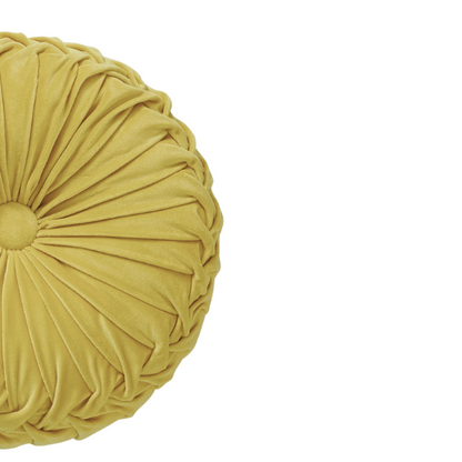Yellow velvet round throw pillows with pleated detailing and button center, 14.5-inch set of two styled in a cozy, sunlit room.

